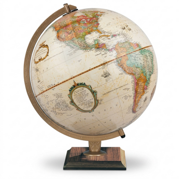 Antique ocean desk globe with bronze meridian and square wood base on white background.