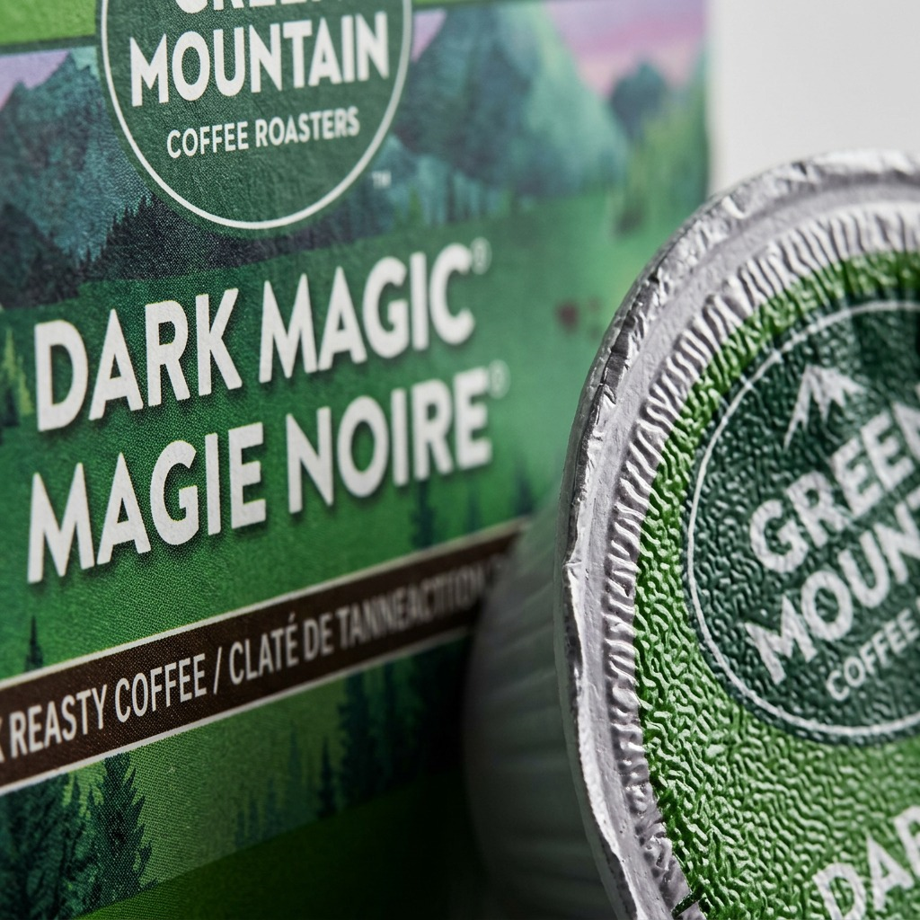 Macro shot focusing on the crisp, complex textures and fine print of the K-Cup pod and carton surface.