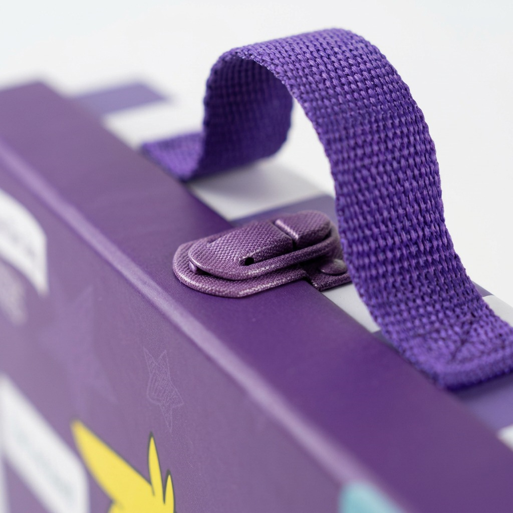 Macro photograph of the purple fabric strap and metal clasp on the 'Open The Joy' kit.