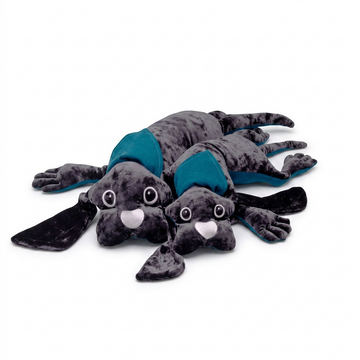 A high-resolution product shot of the fdmt manimo Weighted Dog, showing its dark grey mottled fur and teal neck scarf.