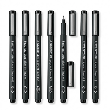 A high-resolution, centered flat lay photograph of eight Staedtler Pigment Liner technical pens, in black barrels with metallic caps, showing the range of sizes from 0.05mm to 1.2mm. All standard brand markings are visible.