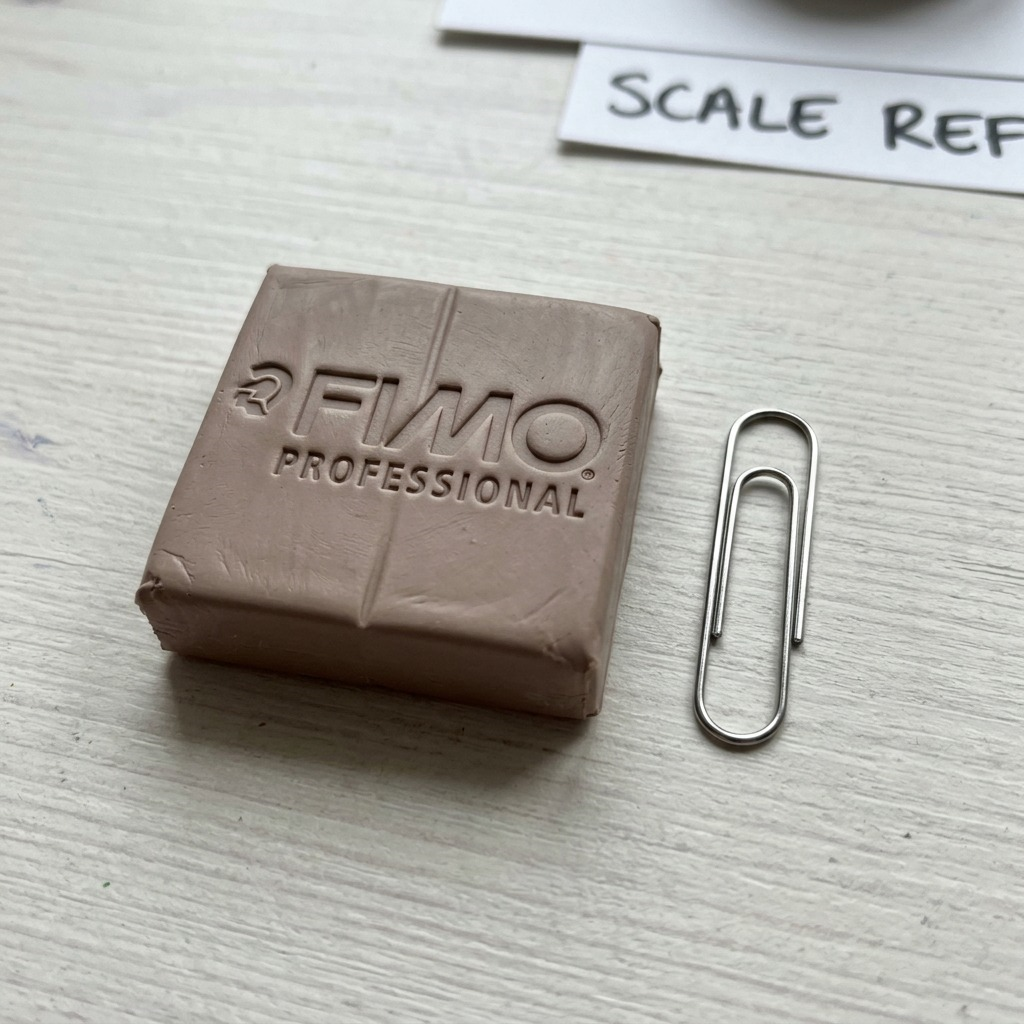 A premium high-resolution ecommerce hero shot of the STAEDTLER Fimo Professional Taupe modelling clay block, featuring crisp details and a clean shadow on a white background.
