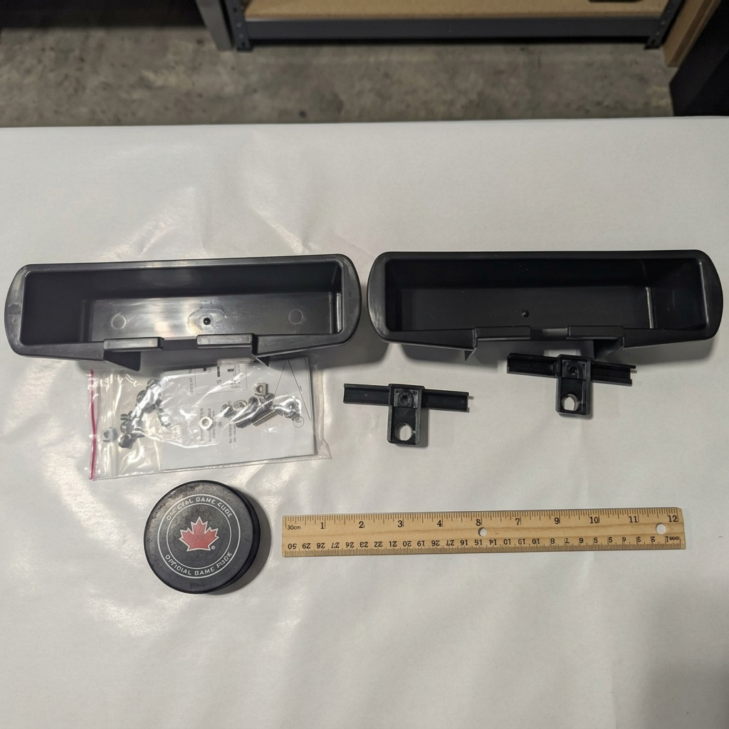 RAKABOT Titan Expansion Kit featuring two black plastic storage containers, two hooks, and hardware.