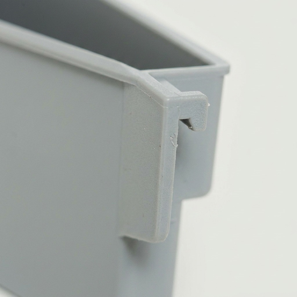 Macro view of the precision interlocking hook and texture of the grey plastic Rakabot container.