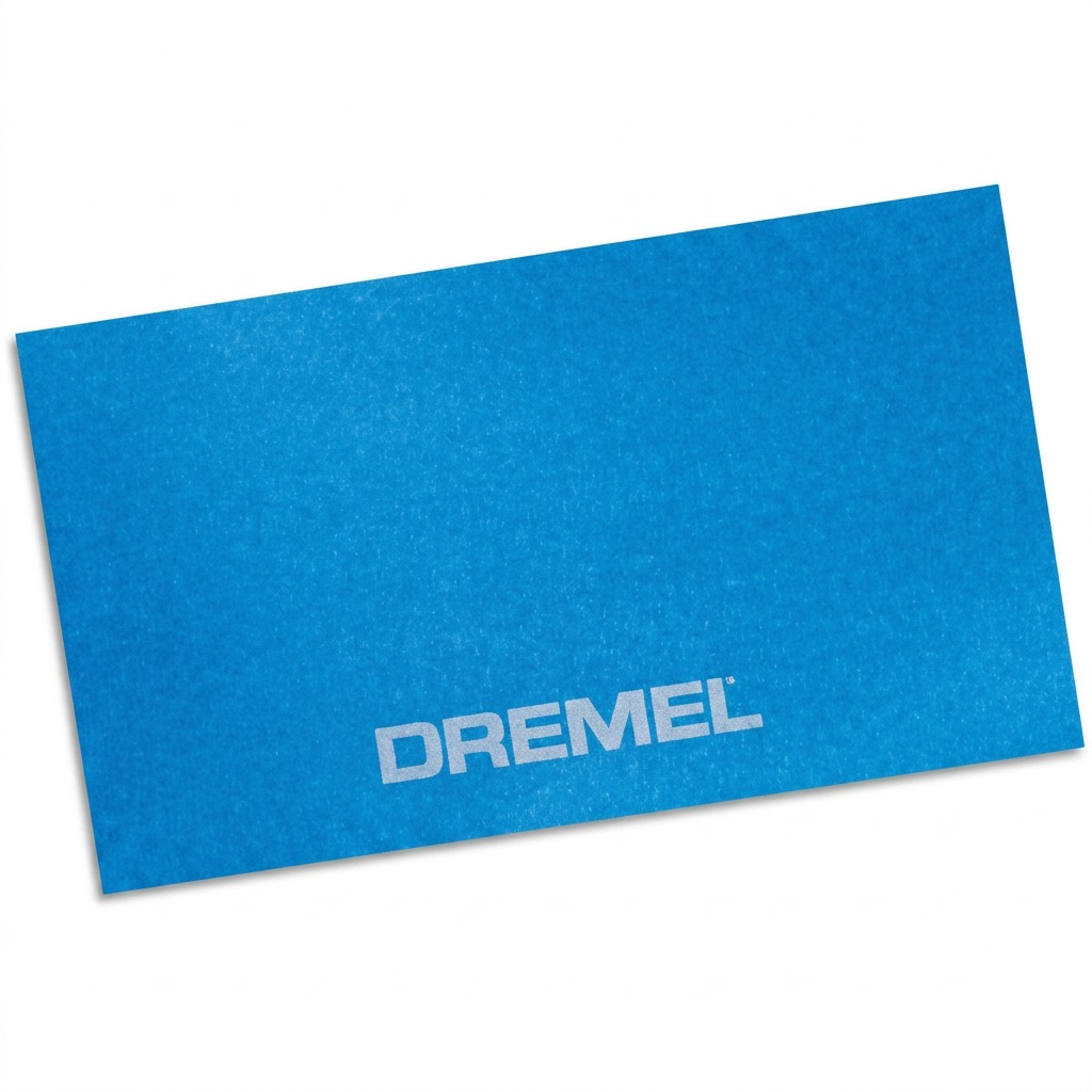 A high-resolution, centered image of a light blue rectangular painter's tape piece, featuring the "DREMEL" logo, on a seamless white background.